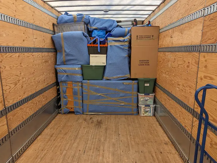 Furniture and cartons loaded and strapped for delivery