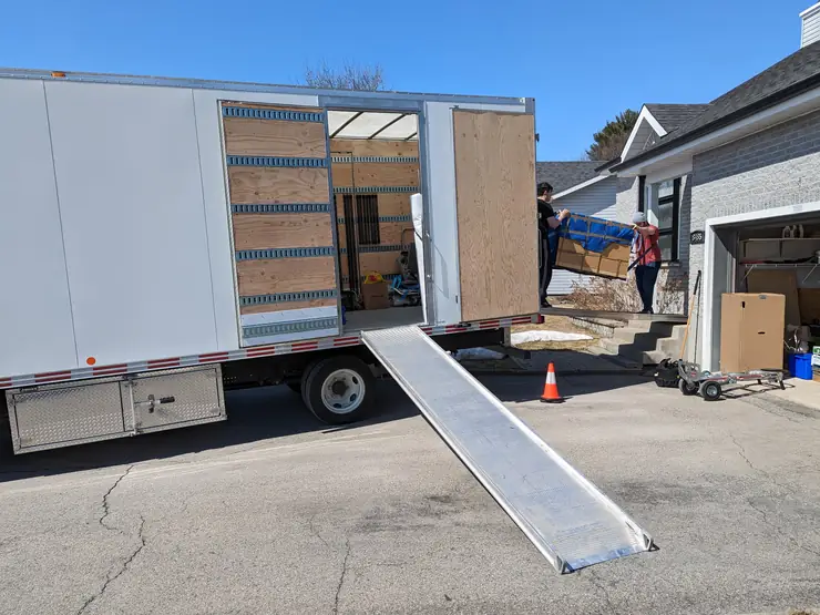 Simplex moving truck parked at a house with the ramp down for a local move