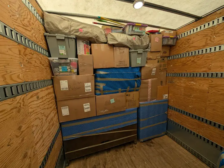 Office boxes and file containers stacked and strapped in a moving truck