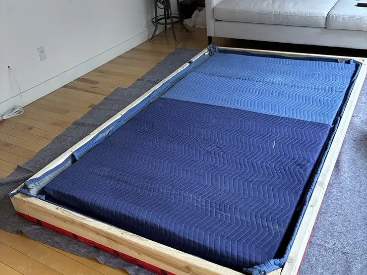 Large flat item wrapped and padded before being carried out