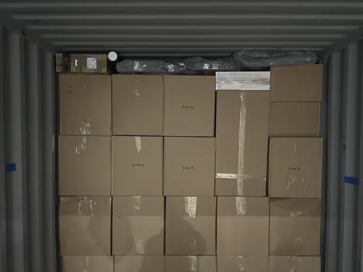 Storage container packed floor to ceiling with labelled cartons